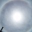 Image of cirrus clouds appearing to circle around the sun.